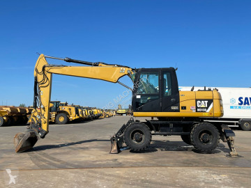 Caterpillar M313 D VA - Outriggers + Blade