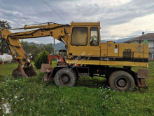 Caterpillar 214 BTF gravemaskine på hjul brugt