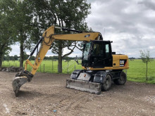 Caterpillar M313 tweedehands graafmachine op banden