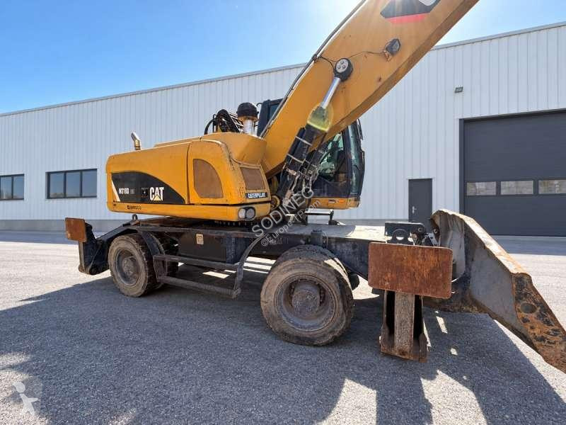 Багер Caterpillar MH