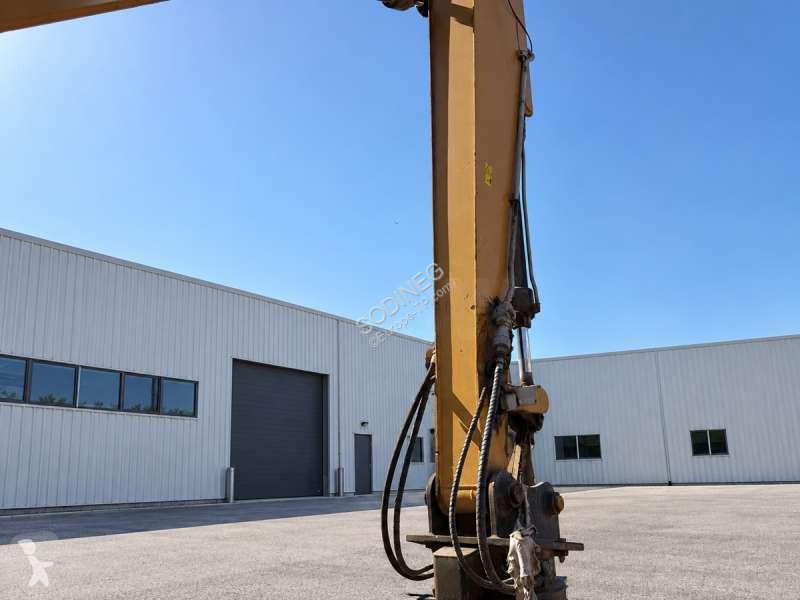 Багер Caterpillar MH