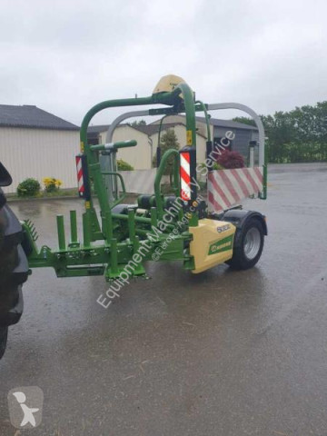 Krone with twin wrapping arm Bale wrapper