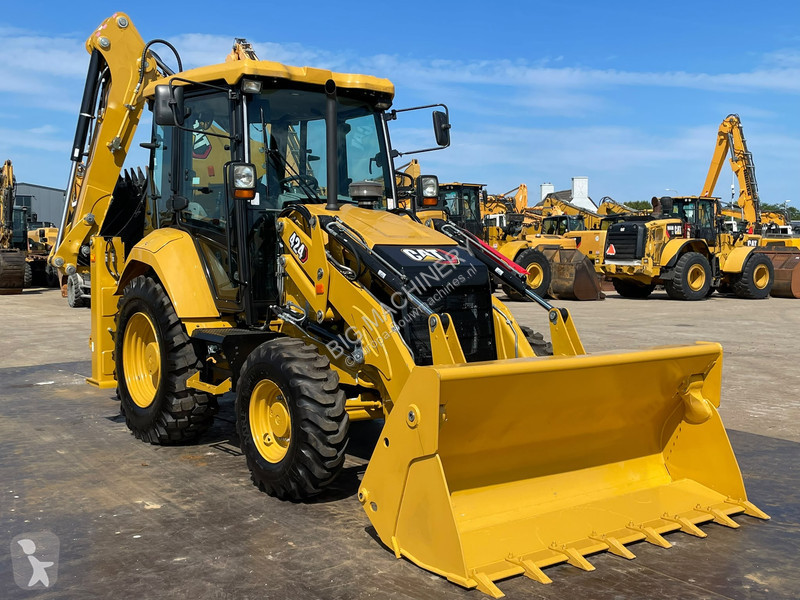Traktor med grab Caterpillar 424