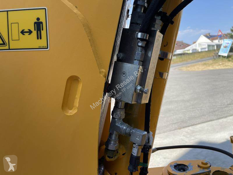 Traktor med grab Caterpillar