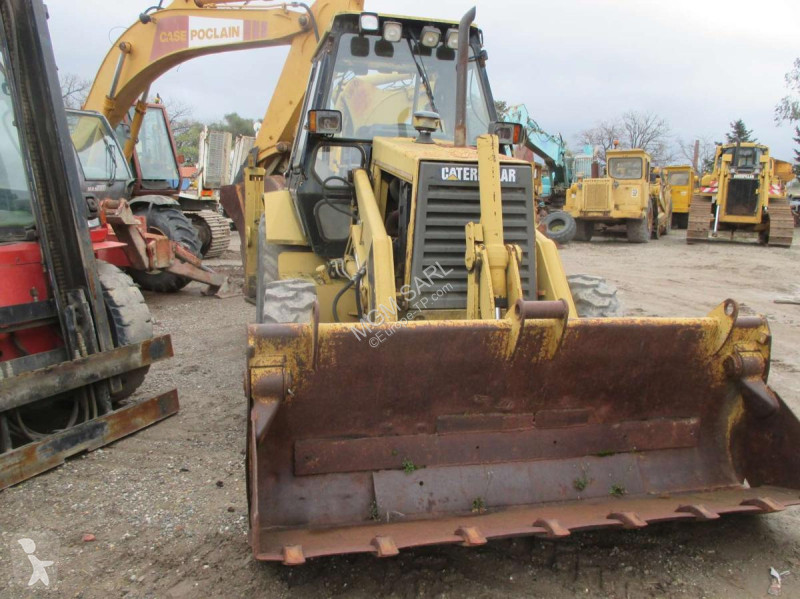 Traktor med grab Caterpillar