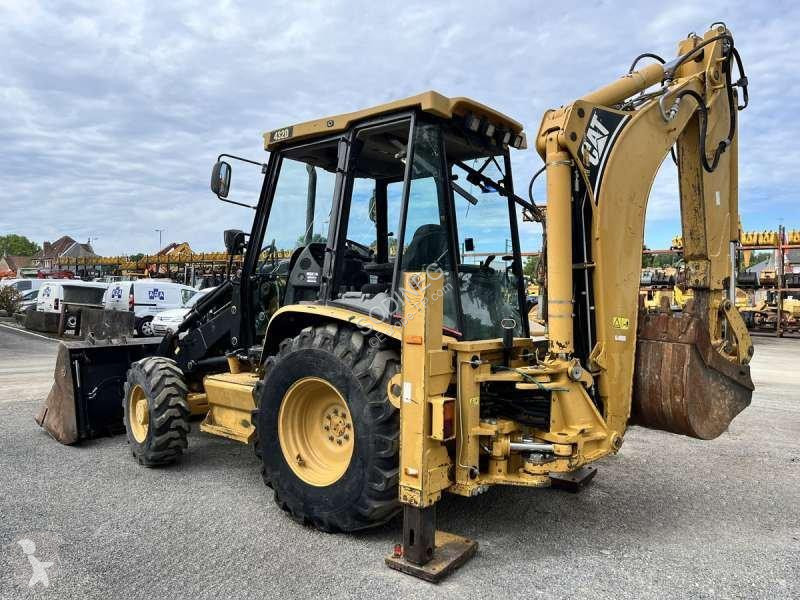 Traktor med grab Caterpillar