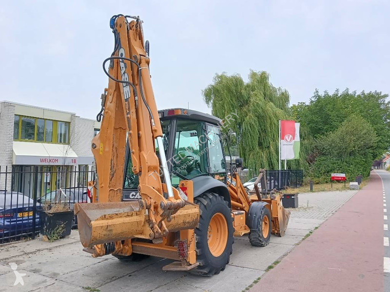 Traktor med grab Case backhoe loader graaf laad...
